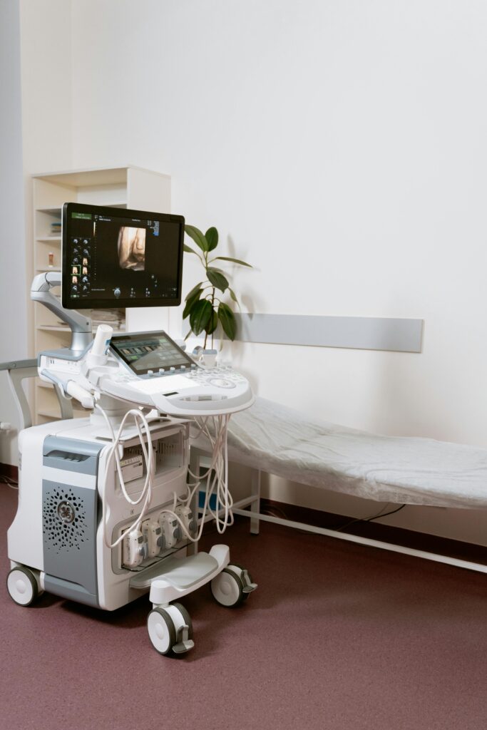 pexels-photo-7089029-7089029 Ultrasound machine setup in a clinic room, ready for patient examination.
